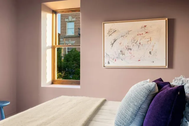 a bed room with a bed and a window