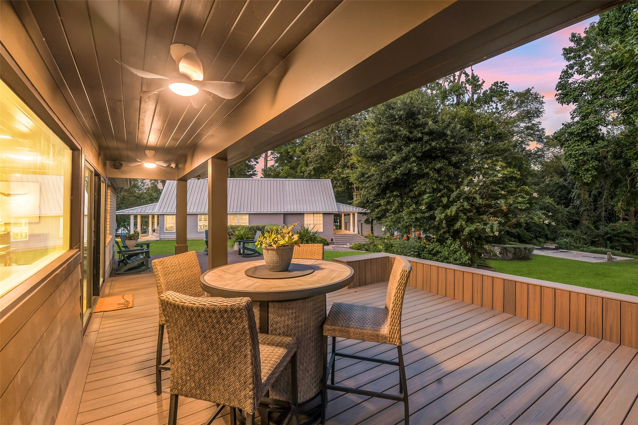 0 Camilla Lake Road Coldspring, TX 77331 - Photo 16 of 50 Brick House: Covered back porch with ceiling fans and ambient lighting offers a peaceful place to relax while overlooking the landscaped outdoor gathering areas.