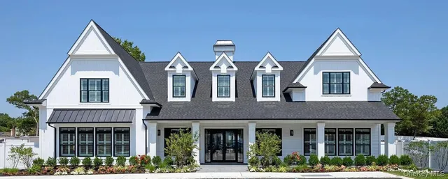 a view of a brick house with large windows
