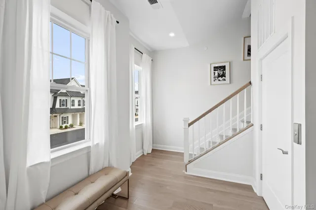 a view of entryway with a window and wooden floor