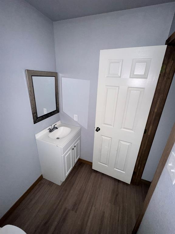 450 Derrs Chapel Road Italy, TX 76651 - Photo 11 of 13 Bathroom featuring a vanity with white cabinetry, a single basin sink, and a framed mirror