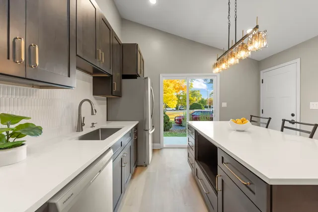 a kitchen with a sink and a refrigerator