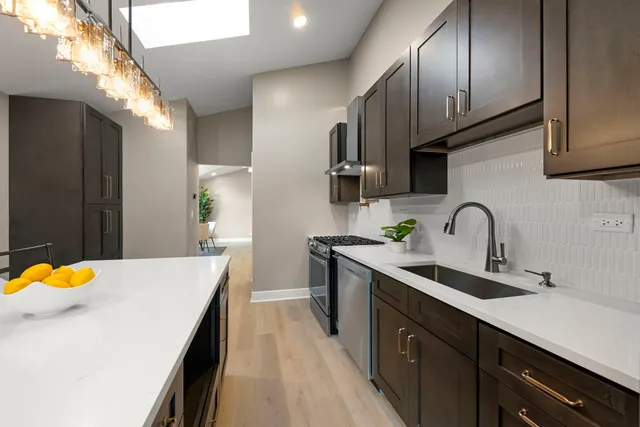 a kitchen with stainless steel appliances a sink stove and cabinets