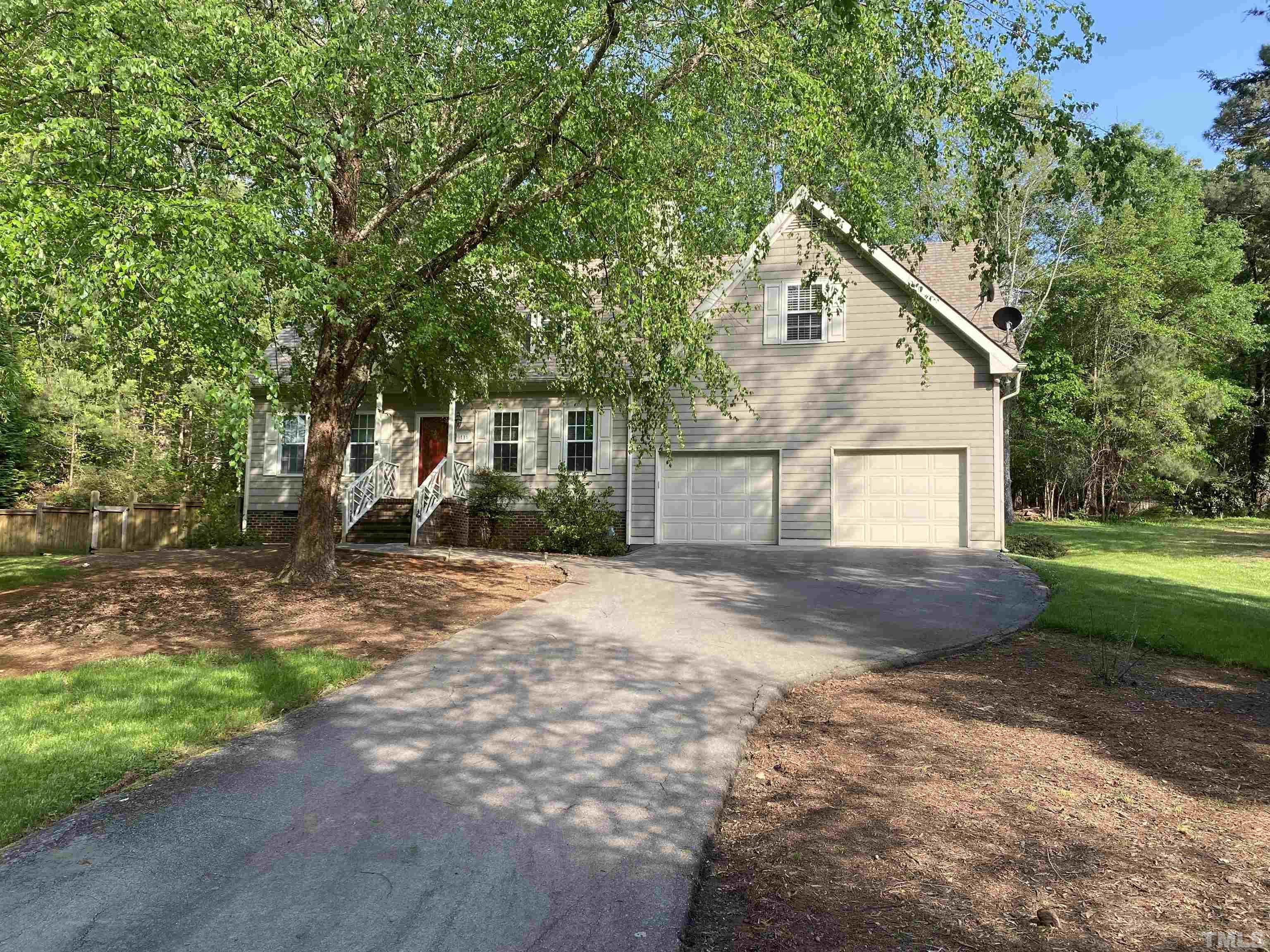 116 Baldwin Drive Durham, NC 27712 - Photo 1 of 33 a view of a white house with a yard and large tree