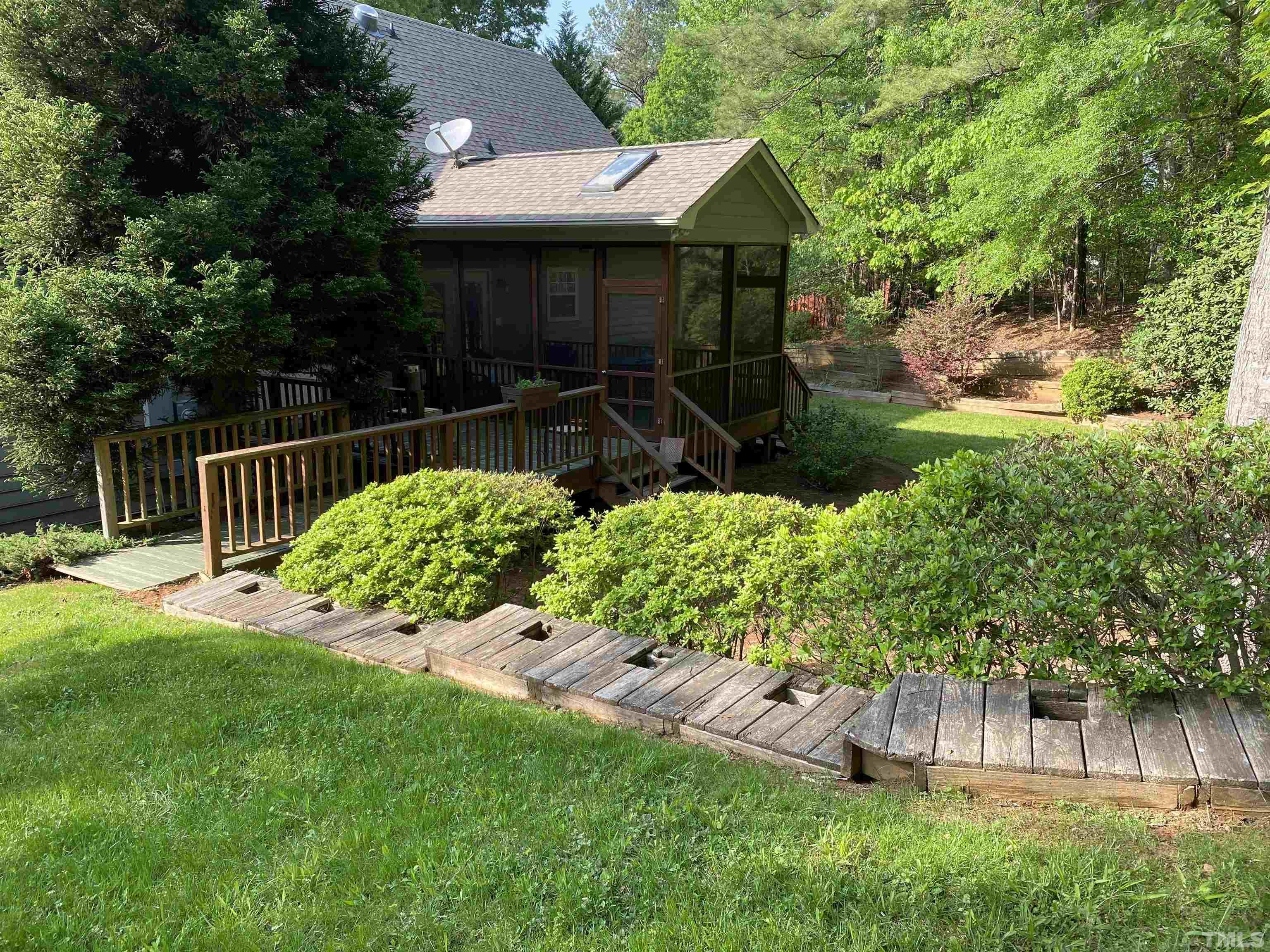 116 Baldwin Drive Durham, NC 27712 - Photo 4 of 33 a front view of a house with a yard table and chairs