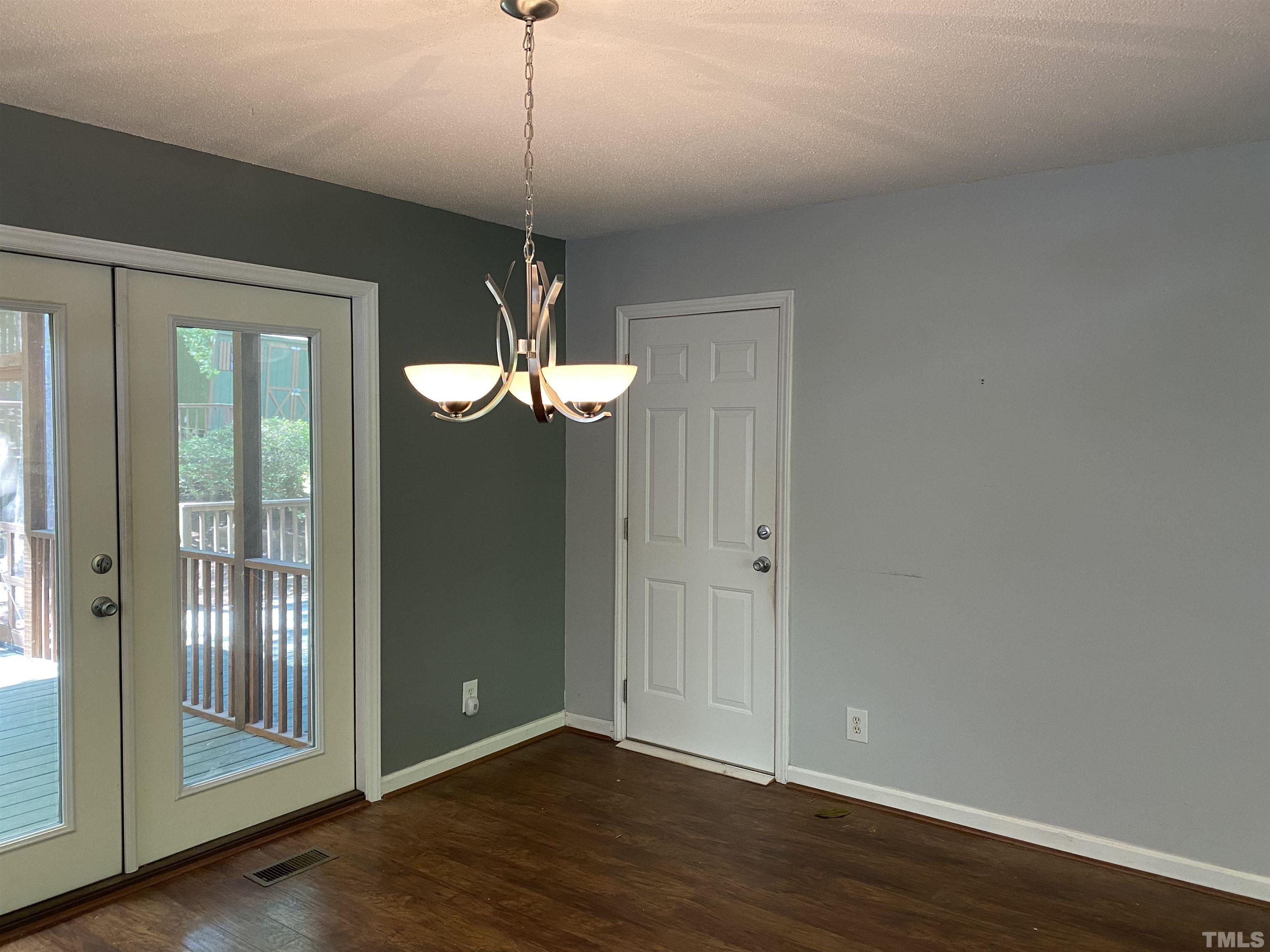 116 Baldwin Drive Durham, NC 27712 - Photo 8 of 33 a view of a room with wooden floor chandelier and window