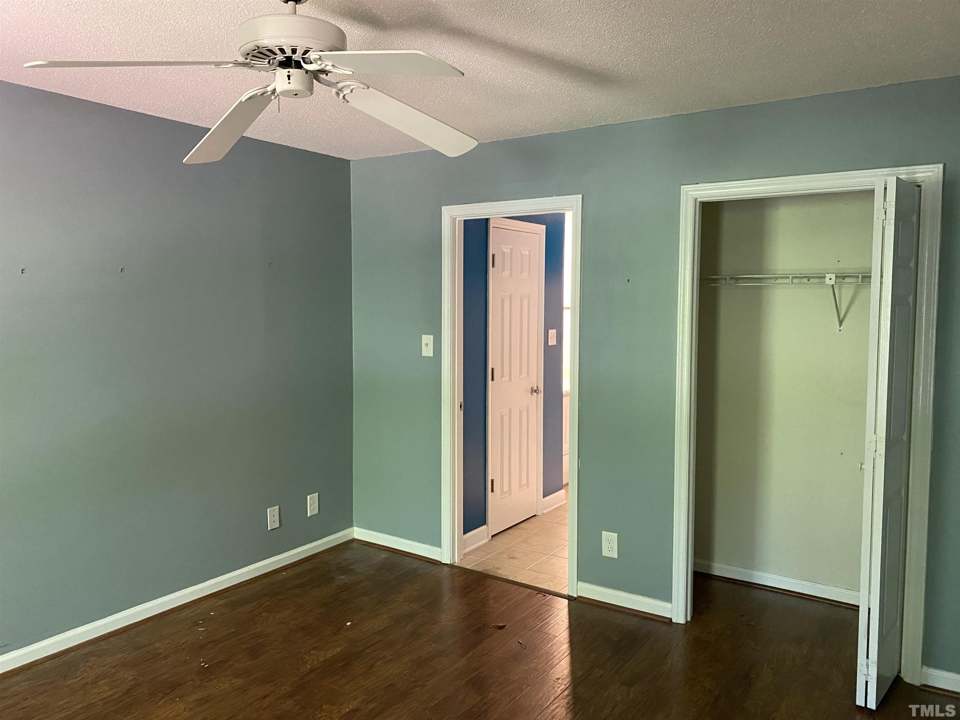 116 Baldwin Drive Durham, NC 27712 - Photo 10 of 33 an empty room with wooden floor closet and windows
