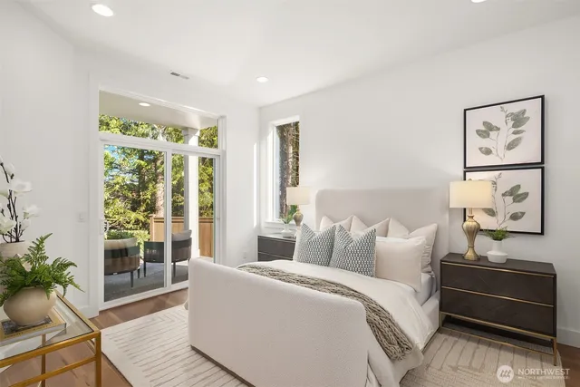 a spacious bedroom with a bed and glass window