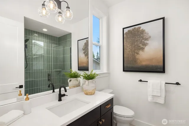 a bathroom with a sink a toilet and mirror