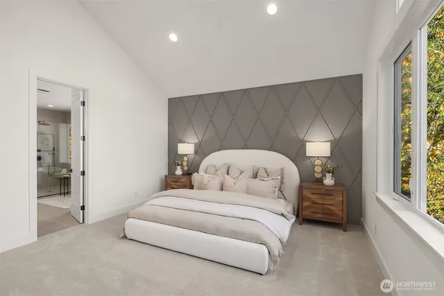 a bedroom with a bed and a large window