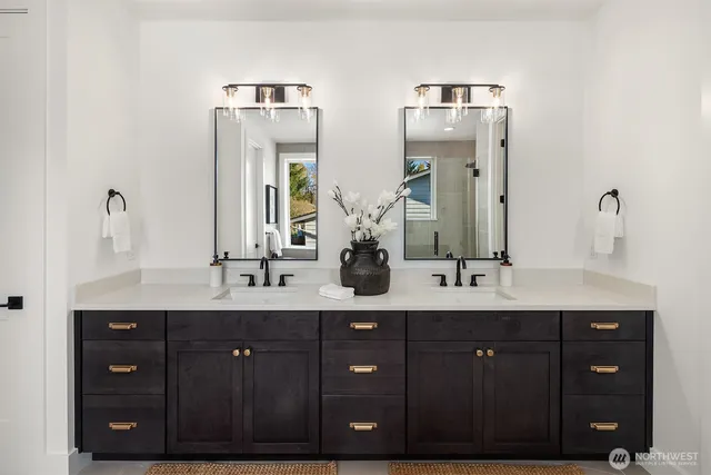 a bathroom with a double vanity sink and mirror