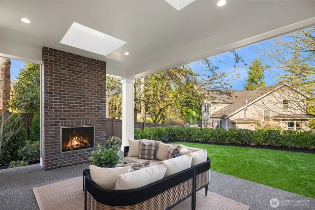 a outdoor space with patio fireplace couches and potted plants