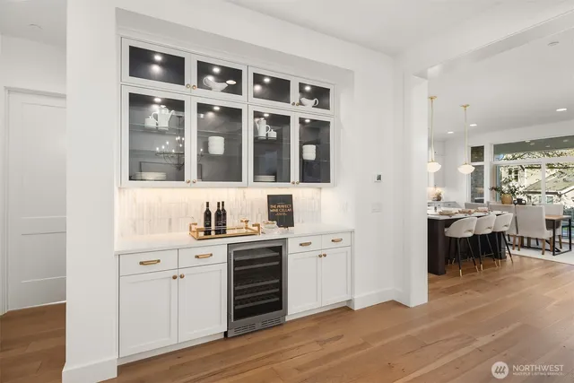 a kitchen with granite countertop a sink cabinets and wooden floor