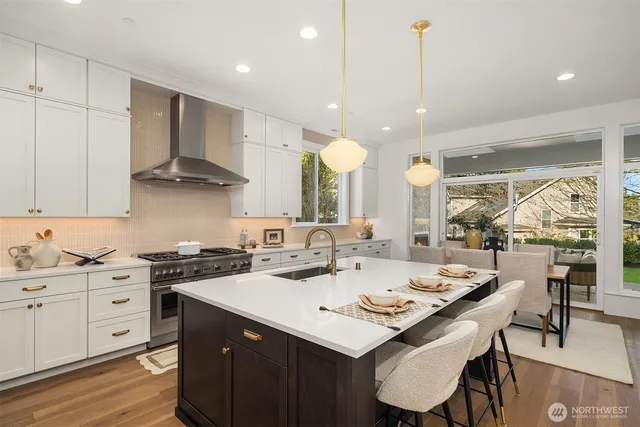 a kitchen with a sink a stove a dining table and chairs