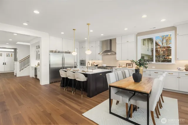 a large kitchen with a table and chairs