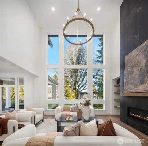 a living room with furniture a large window and a fireplace
