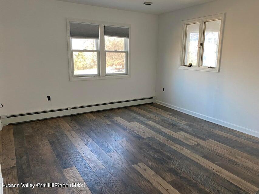 119 Baker Road Kerhonkson, NY 12446 - Photo 15 of 15 an empty room with wooden floor and windows