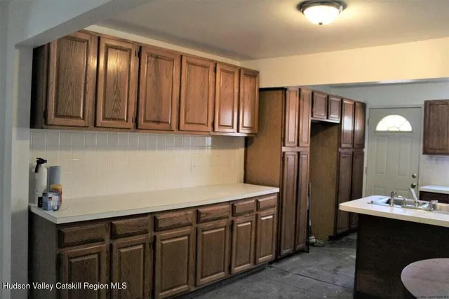 a kitchen with stainless steel appliances granite countertop a sink refrigerator and cabinets