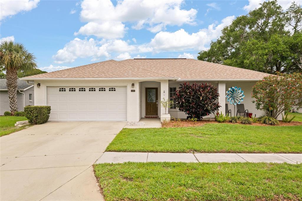 11241 Rollingwood Drive Port Richey, FL 34668 - Photo 1 of 26 a front view of a house with a yard