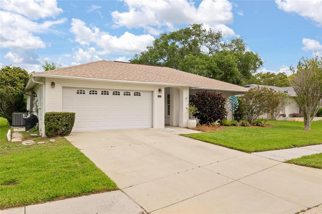 11241 Rollingwood Drive Port Richey, FL 34668 - Photo 2 of 26 a view of a house with a yard