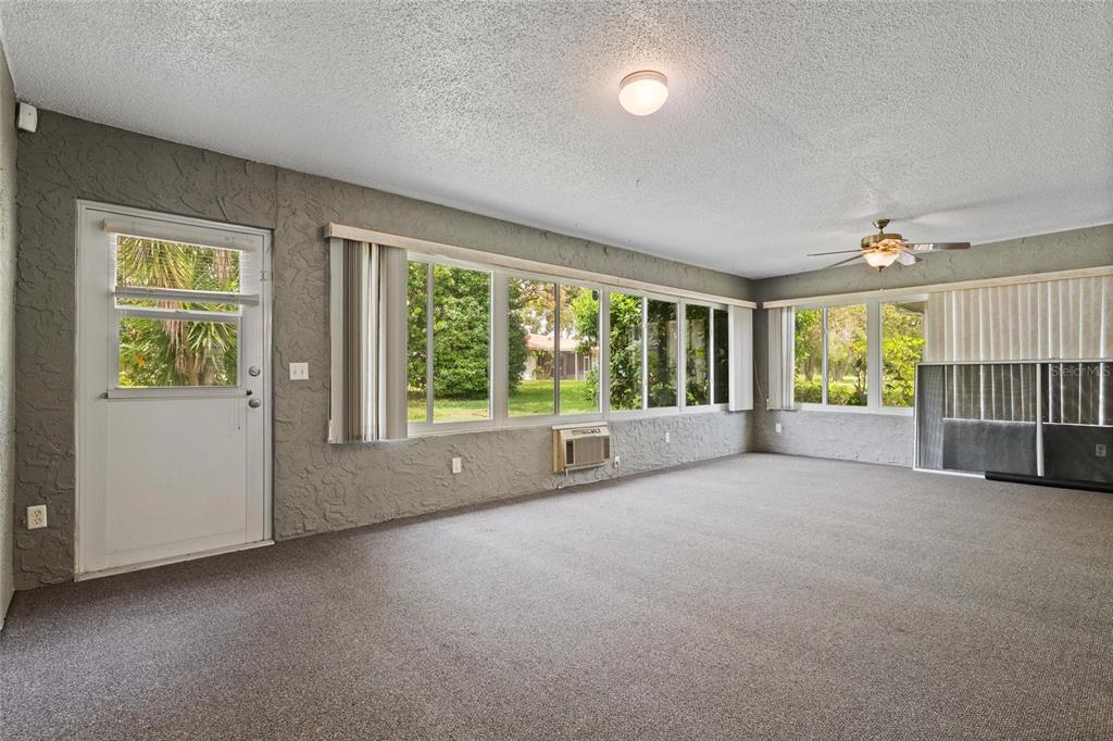 11241 Rollingwood Drive Port Richey, FL 34668 - Photo 22 of 26 a view of empty room with floor to ceiling window and an empty room