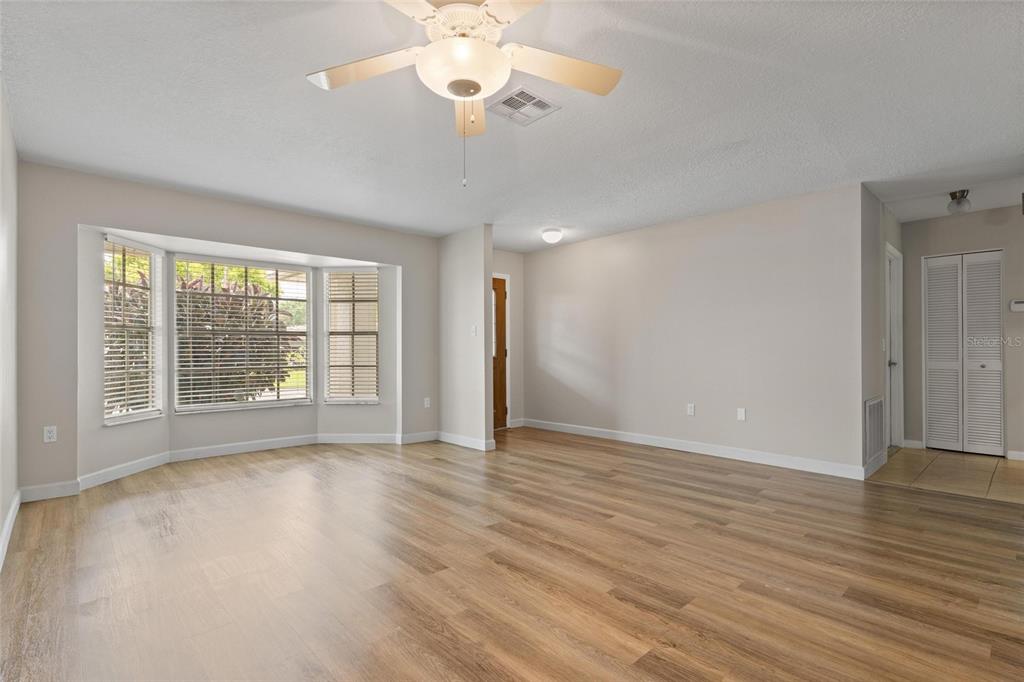 11241 Rollingwood Drive Port Richey, FL 34668 - Photo 5 of 26 a view of an empty room with wooden floor and a window