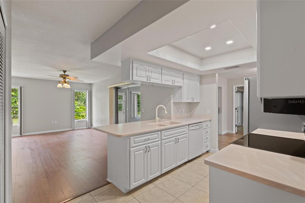 11241 Rollingwood Drive Port Richey, FL 34668 - Photo 9 of 26 a kitchen with a sink and refrigerator