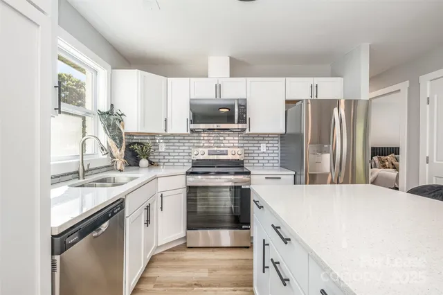 a kitchen with a stove sink and refrigerator