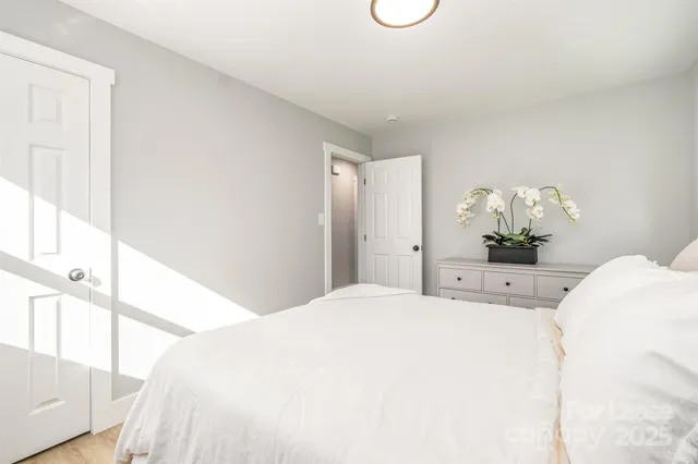 a bedroom with a bed and a potted plant