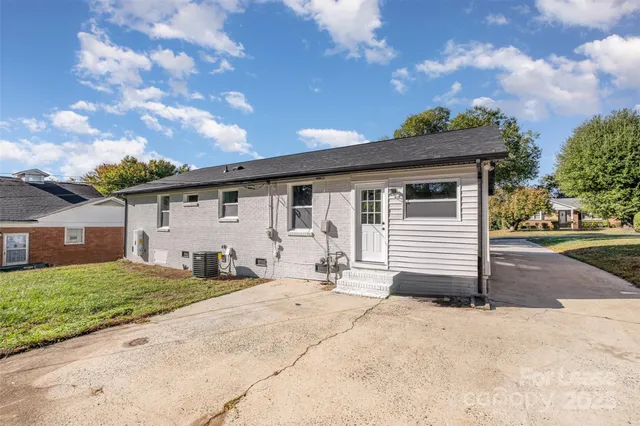 a backyard of a house with table and chairs