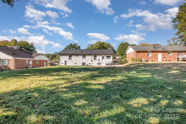 a house view with swimming pool and trees in the background