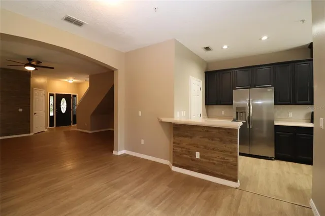 a kitchen with granite countertop a refrigerator and a sink