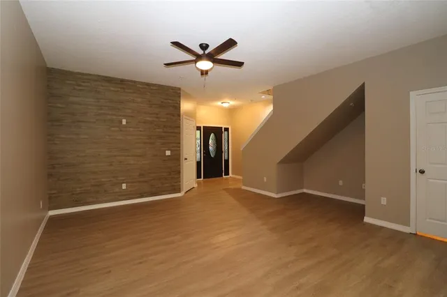a view of a livingroom with a ceiling fan and window