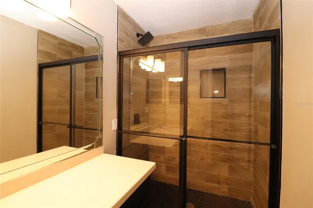 a bathroom with a shower and a sink