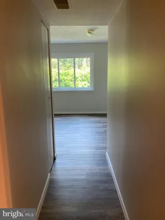 a view of hallway with wooden floor