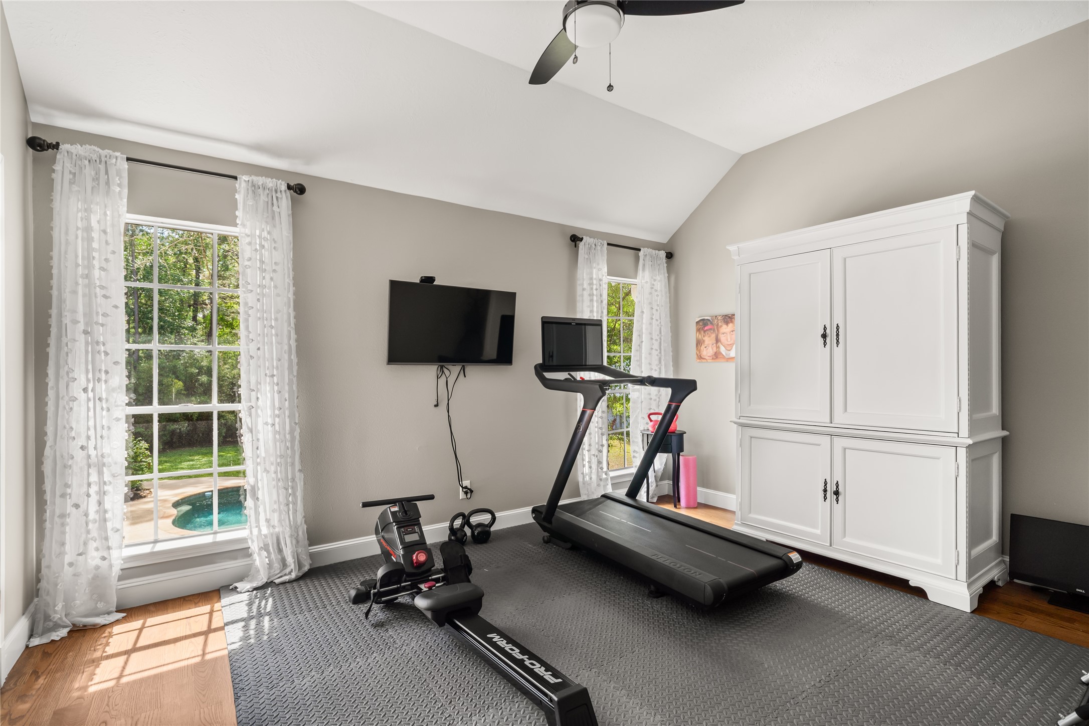 36 Wind River Drive Conroe, TX 77384 - Photo 36 of 45 This portion of the room features bright windows with views of a pool.