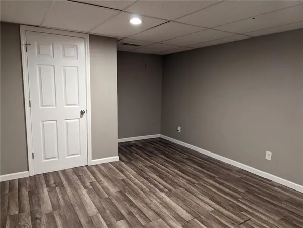 a view of a room with wooden floor