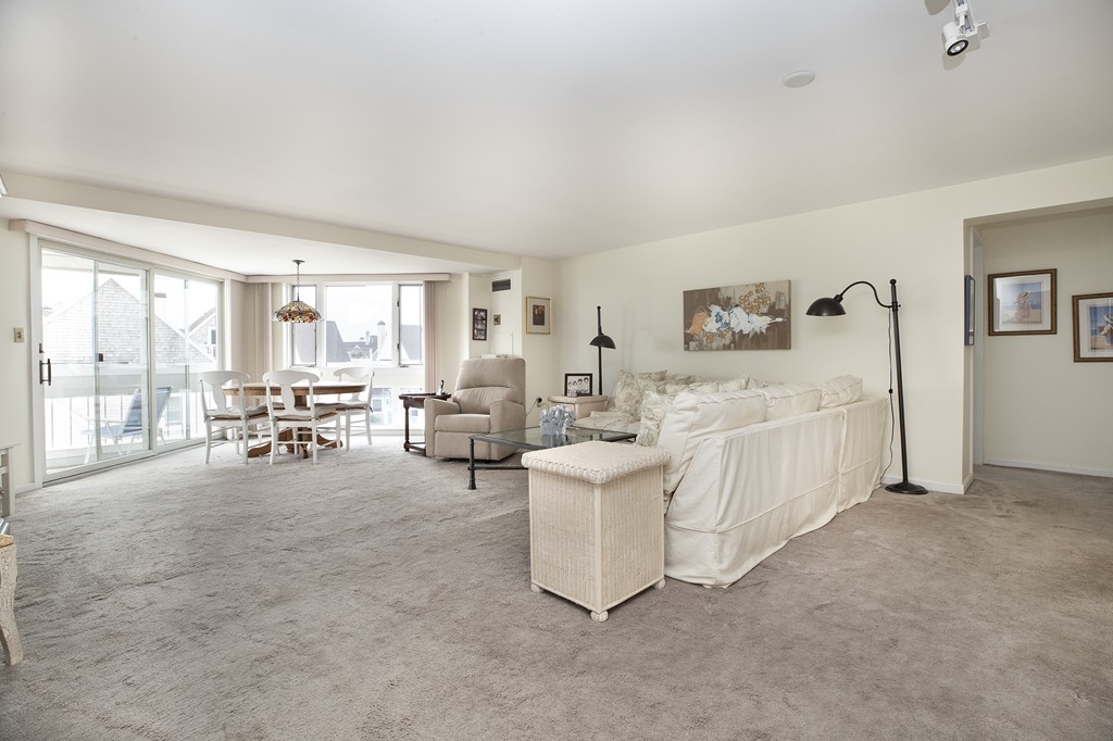 304 Commodore Court, Unit 304 Hull, MA 02045 - Photo 3 of 12 a living room with furniture and a large window