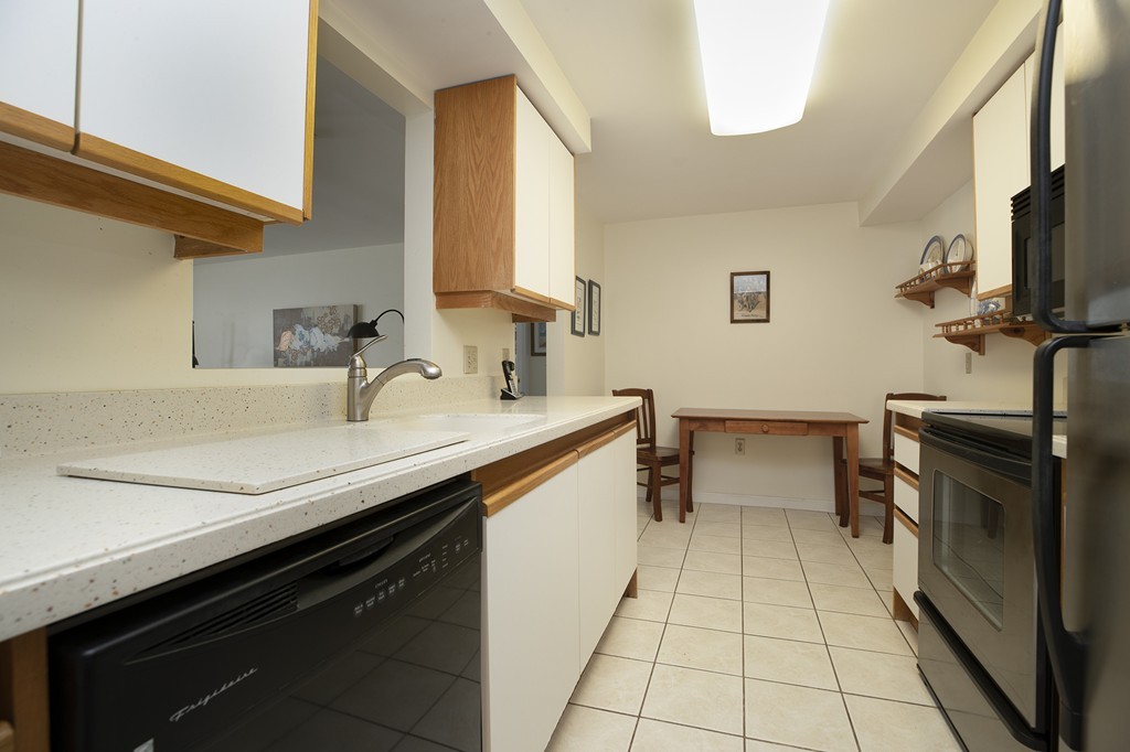 304 Commodore Court, Unit 304 Hull, MA 02045 - Photo 6 of 12 a kitchen with a sink and a stove top oven