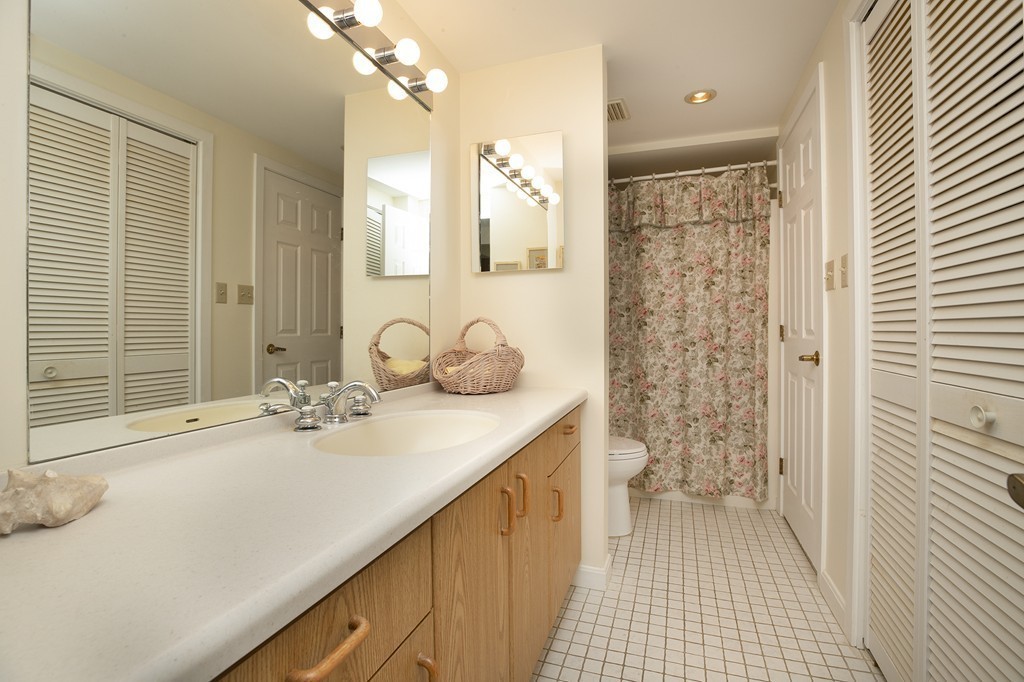 304 Commodore Court, Unit 304 Hull, MA 02045 - Photo 8 of 12 a bathroom with a sink a toilet and shower