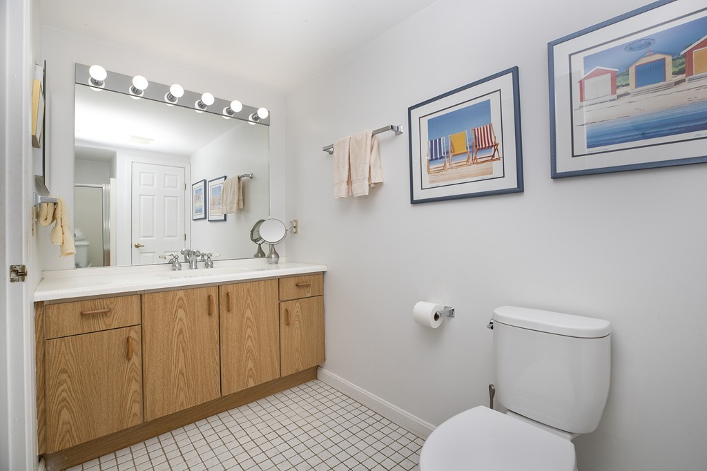 304 Commodore Court, Unit 304 Hull, MA 02045 - Photo 10 of 12 a bathroom with a toilet a sink and mirror