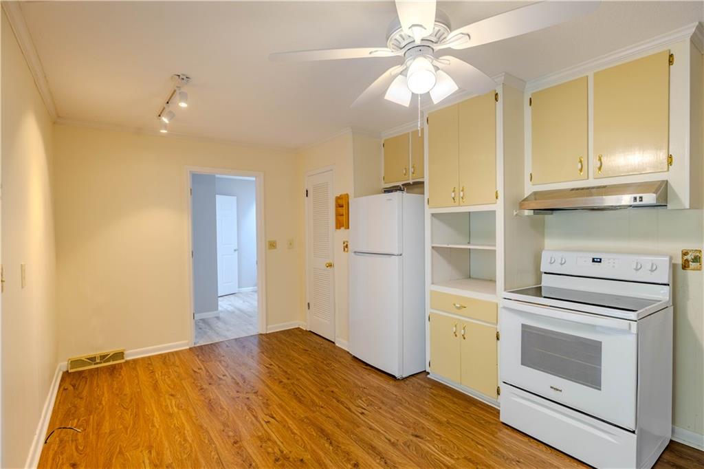 16 Drexel Drive Northwest Rome, GA 30165 - Photo 9 of 27 a kitchen with a stove cabinets and wooden floor