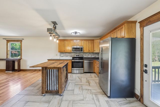 a kitchen with stainless steel appliances granite countertop a refrigerator and a stove