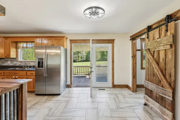 a view of a kitchen with a refrigerator cabinets and a floor to ceiling window