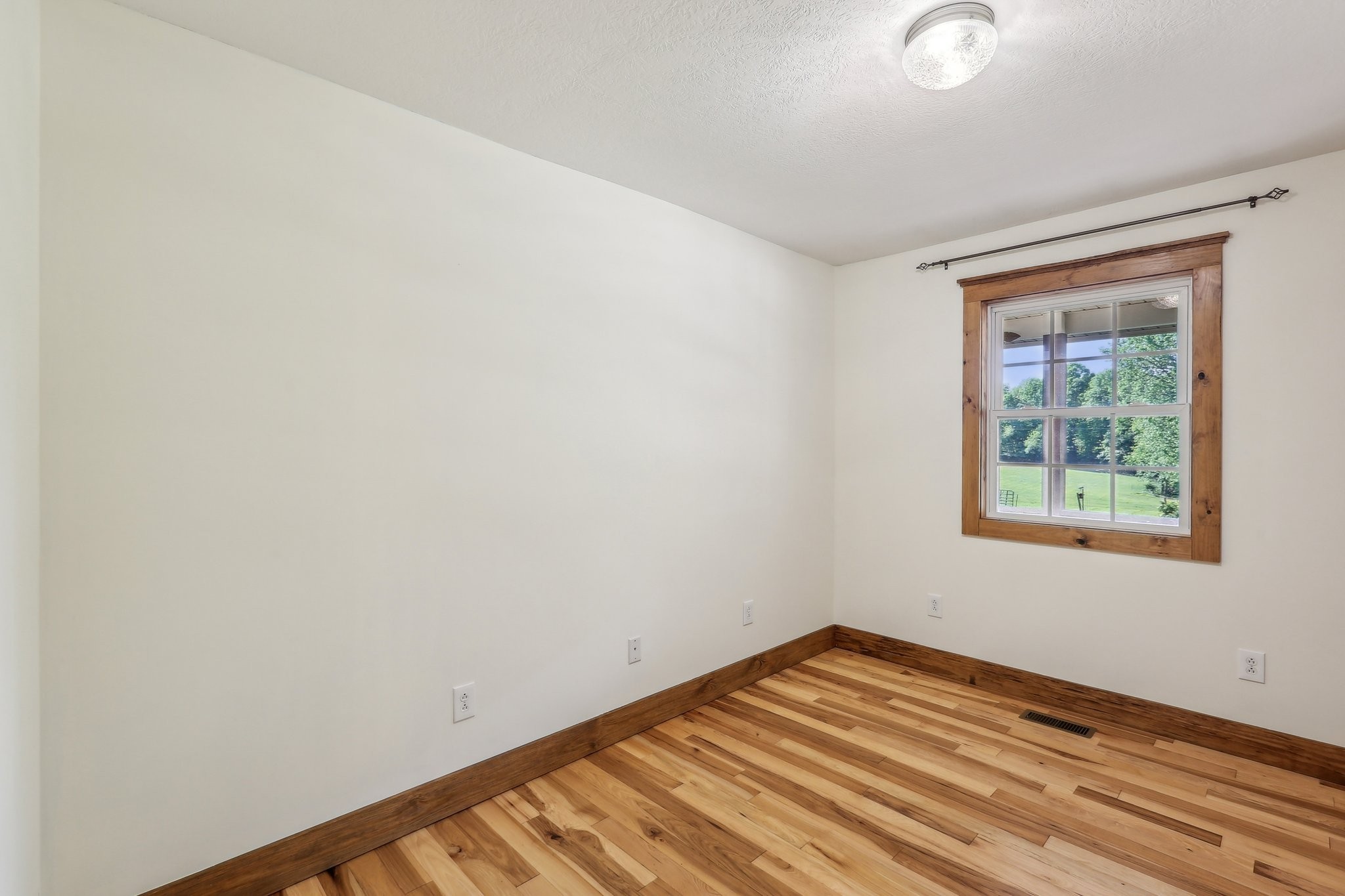 46 Seay Lane Erin, TN 37061 - Photo 19 of 47 a view of empty room with wooden floor and fan