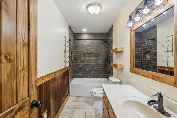 a bathroom with a sink a bathtub and shower