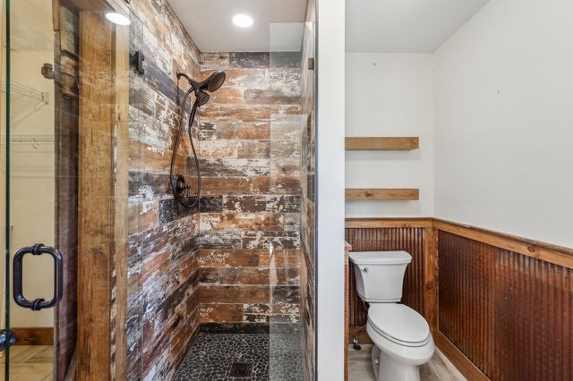 a bathroom with a toilet and a shower