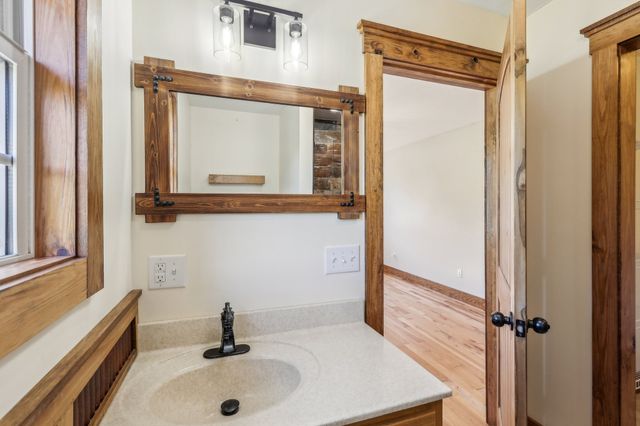 a bathroom with a sink and a mirror