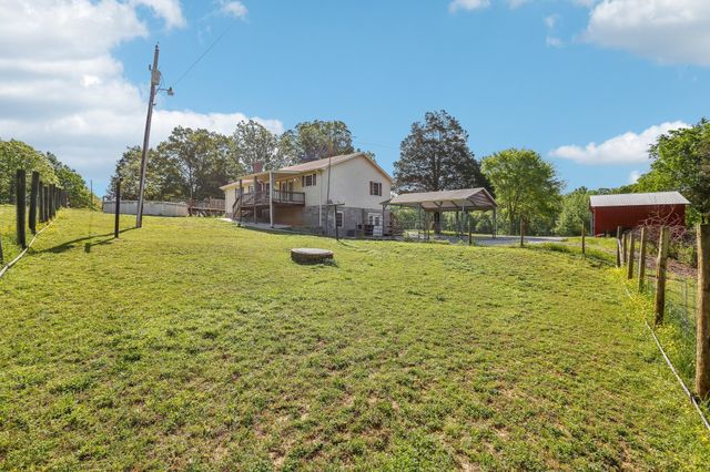 a swimming pool with outdoor seating and yard