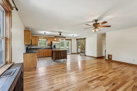 a view of kitchen with furniture and wooden floor